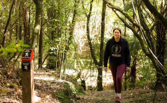 Person walking on a slight uphill at Te Ara Tūpoupou.