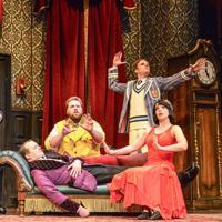 Five theatre actors are on stage performing a scene from 'The Play That Goes Wrong'.