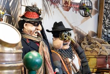 Two funny-looking mannequins dressed in steam-punk-pirate costumes.