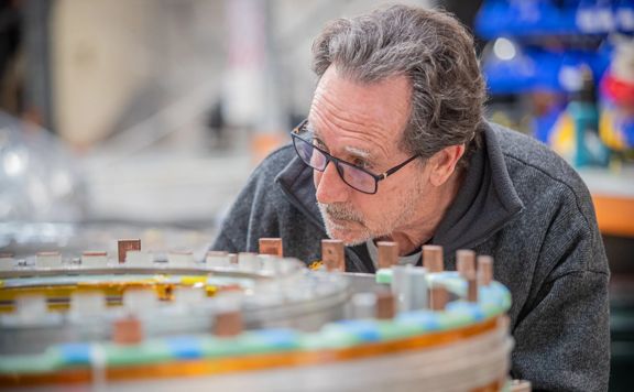 An OpenStar employee inspects a piece of equipment at the company's warehouse.