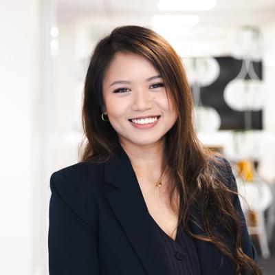 Headshot of Angela Leung. She has long brown hair and is wearing a blazer.