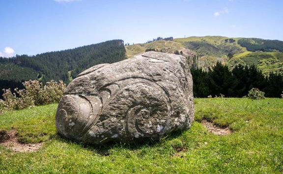 The commemorative rock on Battle Hill Summit Loop, a hiking trail on Battle Hill Farm in Wellington, New Zealand. The stone carved by Rangi Kipa, a Māori sculptor, carver, illustrator and tā moko artist.