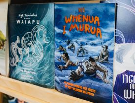 Two Te reo Māori picture books on a shelf.