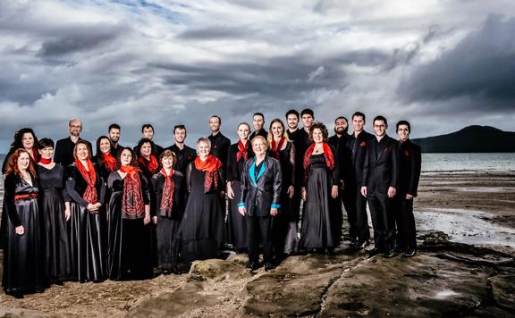 The team from Reimagining Mozart standing on a beach with moody skies ahead.