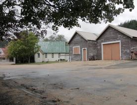 The screen location of Whiitemans Valley, nestled among trees and hills, old buildings have been built to mimic an old town.