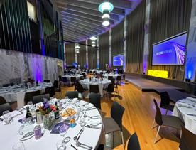 The banquet hall inside the Beehive is set for an event with round tables throughout.