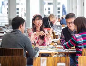 Four people enjoy food and drinks at  Dockside Restaurant & Bar in Wellington.