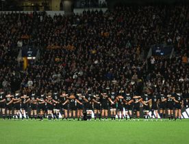 The All Blacks New Zealand rugby team stand on field in Wellington.