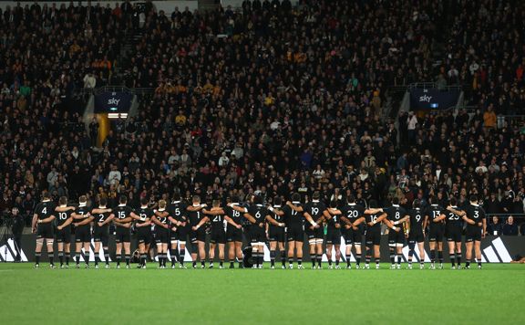 The All Blacks New Zealand rugby team stand on field in Wellington.
