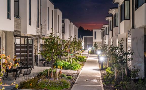 Two rows of apartment blocks at NZCIS. A concrete pathway and gardens run down the middle.