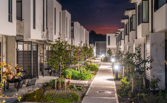 Two rows of apartment blocks at NZCIS. A concrete pathway and gardens run down the middle.