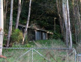 Mangaroa Valley Road screen location, a scenic rural setting with native forest, farmland, and a mountainous backdrop.