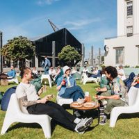 Three friends enjoy food and drinks al fresco at St Johns Bar on Wellington's Waterfront.