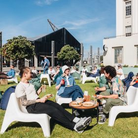 Three friends enjoy food and drinks al fresco at St Johns Bar on Wellington's Waterfront.