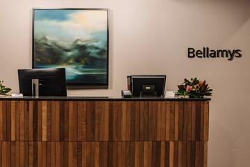 Front desk with wooden panels at Bellamy's restaurant at the Wellington Beehive.