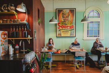 Customers sitting at tables inside The House of Good Fortune.