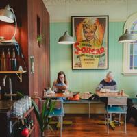 Customers sitting at tables inside The House of Good Fortune.