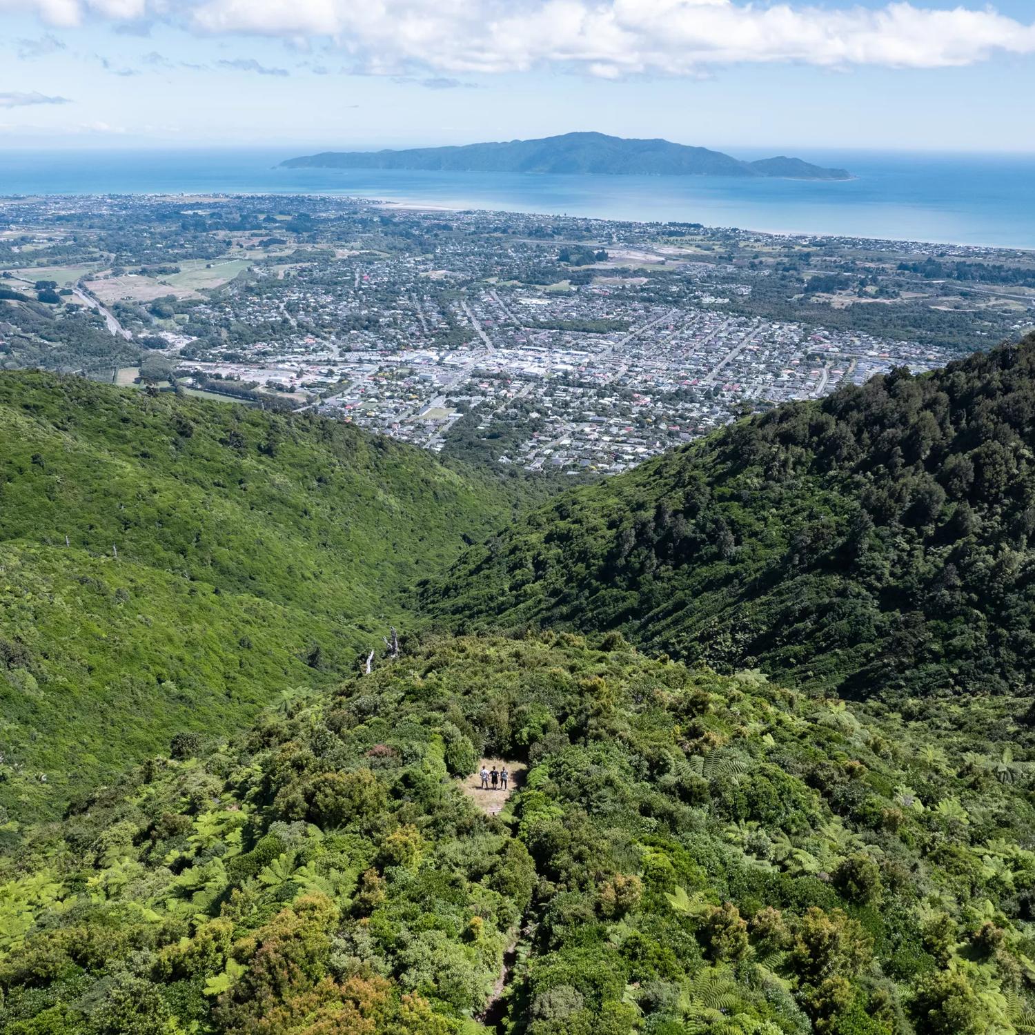 A drone shot from high above the summit of Te Au Track at Hemi Matenga Scenic Reserve  with panoramic views of the Waikanae Estuary and Kapiti Island.