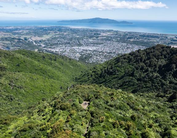 A drone shot from high above the summit of Te Au Track at Hemi Matenga Scenic Reserve  with panoramic views of the Waikanae Estuary and Kapiti Island.