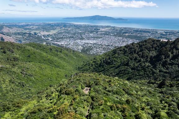 A drone shot from high above the summit of Te Au Track at Hemi Matenga Scenic Reserve  with panoramic views of the Waikanae Estuary and Kapiti Island.