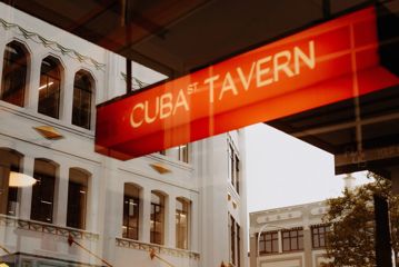 A red sign that reads Cuba St Tavern.
