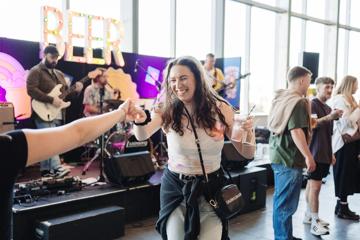 A festival attendee dances at a pop-up performance at Beerana.
