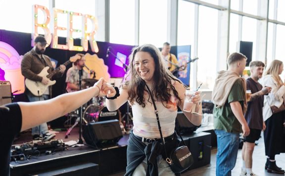 A festival attendee dances at a pop-up performance at Beerana.