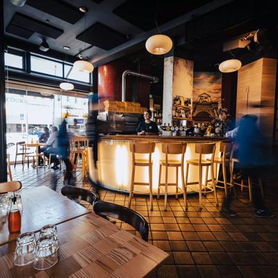 Inside Scopa, an Italian pizzeria on Cuba Street in Te Aro, Wellington. The dimly lit space has copper tiles and modern decor.