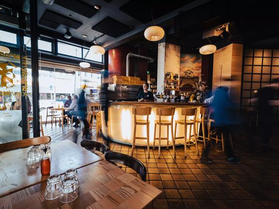 Inside Scopa, an Italian pizzeria on Cuba Street in Te Aro, Wellington. The dimly lit space has copper tiles and modern decor. 