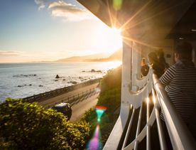 Three people admire the view of the ocean from the Northern Explorer train.