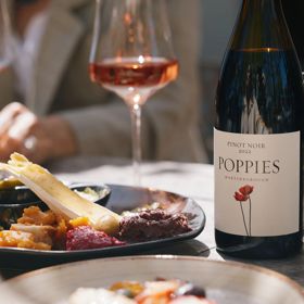 Elegant tasting platter next to a bottle of Rose at Poppies
