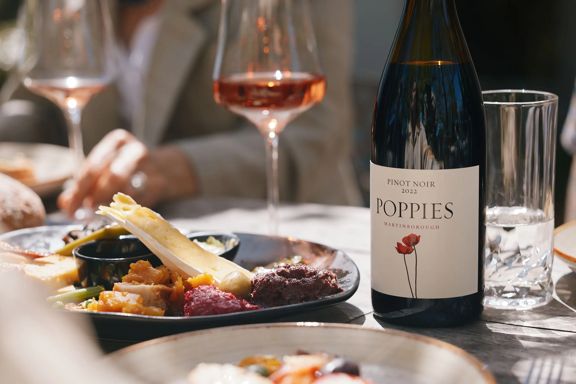 Elegant tasting platter next to a bottle of Rose at Poppies