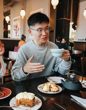 A person chats with friends over coffee and pastries at Floriditas.