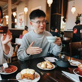 A person chats with friends over coffee and pastries at Floriditas.