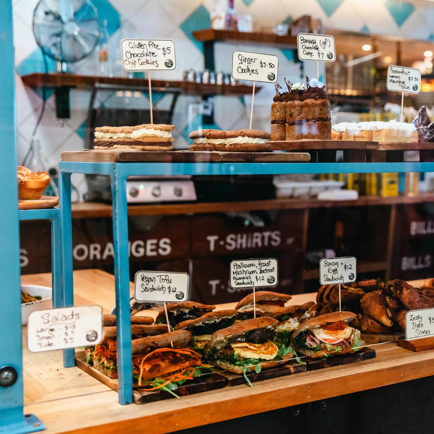 The counter at Seashore Cabaret, a cafe in Petone, Lower Hutt. There are baked goods and sandwiches on display.