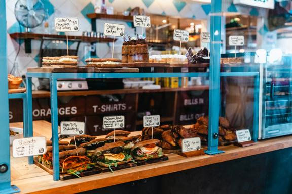 The counter at Seashore Cabaret, a cafe in Petone, Lower Hutt. There are baked goods and sandwiches on display.