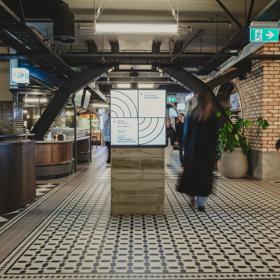 Long ecposure shot of people walking through Willis lane, underneath Lambton Quay.