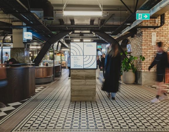 Long ecposure shot of people walking through Willis lane, underneath Lambton Quay.