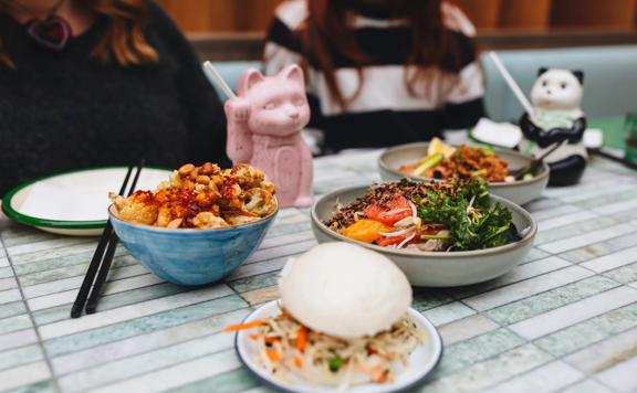 Four different dishes on a table at Mr. Go's.