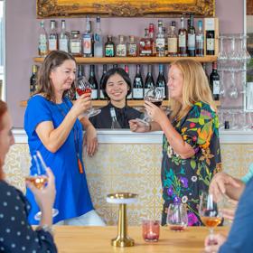 2 customers sniff their wine at Karahui wine bar.