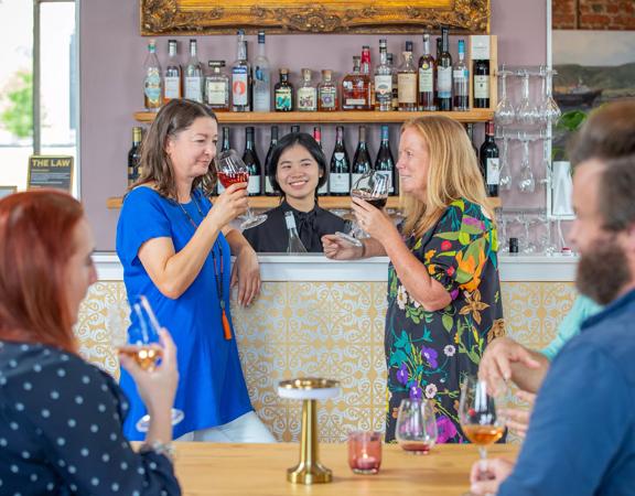 2 customers sniff their wine at Karahui wine bar.