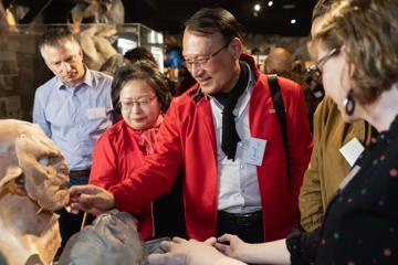 A group of people look at film props at the Wētā Cave and Workshop Tours in Miramar, Wellington, New Zealand.