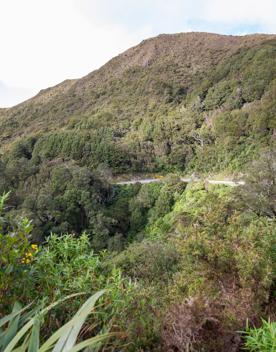 The screen location of Remutaka Summit, wit views of surrounding peaks, lush green bush and steep roads cut into the sides of the mountains.