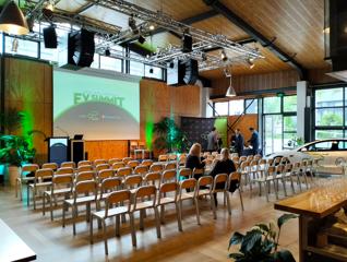 Prefab Hall set up theatre style for a corporate event. Light wooden chairs match the floor and walls.