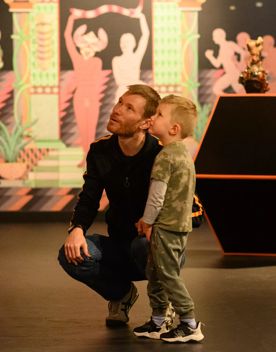 A parent and child stare at an art installation inside the City Gallery.