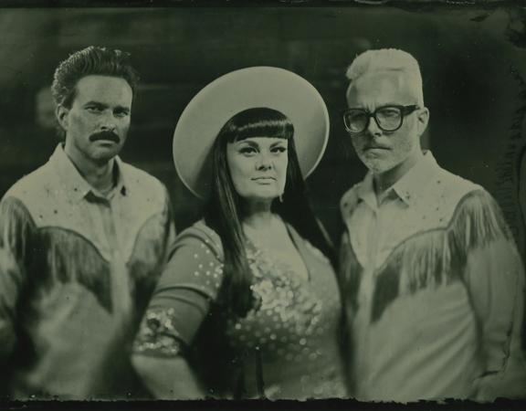 Tami Neilson and two fellow musicians pose for a photo dressed as fashionable cowboys. 