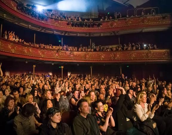 A packed audience cheering and applauding at The Opera House in Te Aro, Wellington. 