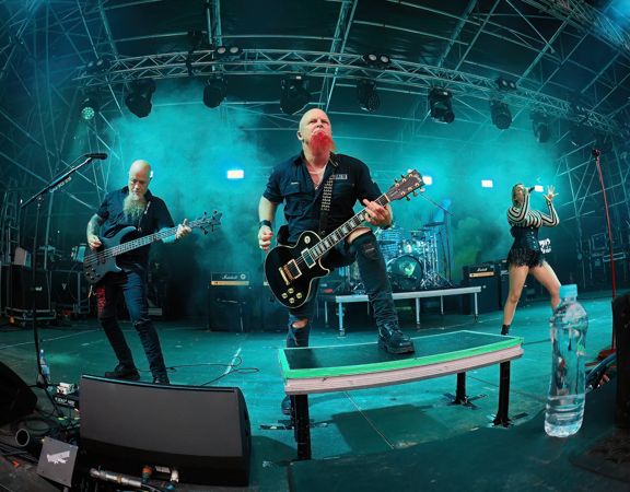 A heavy metal band performs on stage.
