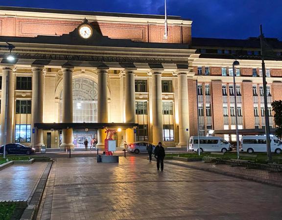 Exterior of Wellington Railway Station, a brick building, at dusk.