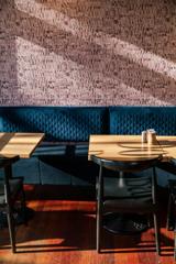 The sun shines in on tables and chairs inside Dough Bakery Upper Hutt.